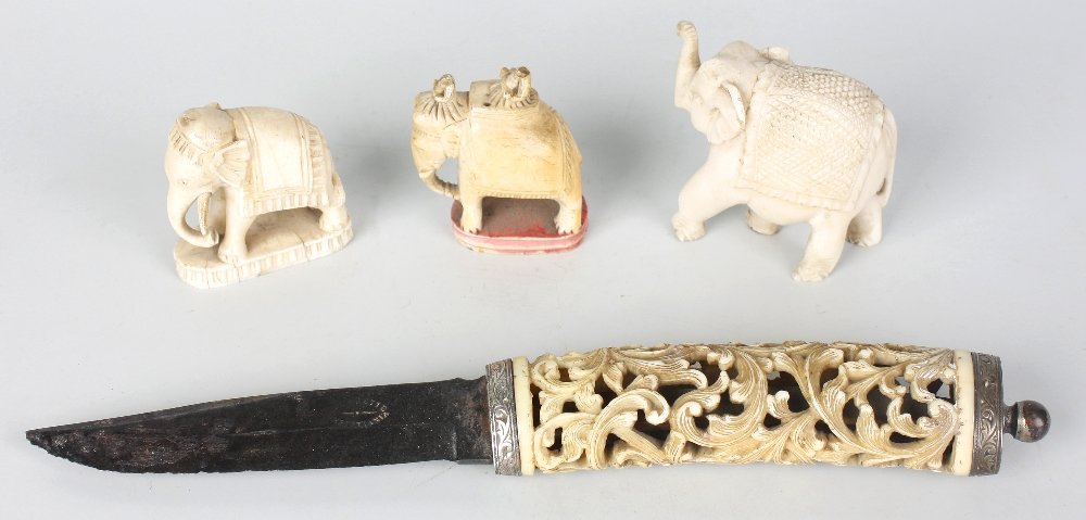 A small group of ivory items: A small group of ivory items, comprising; an Eastern dagger with finely pierced foliate scroll handle, with white metal collar, terminal and pommel, the associated Norwegian steel blade stamped 'Jean 