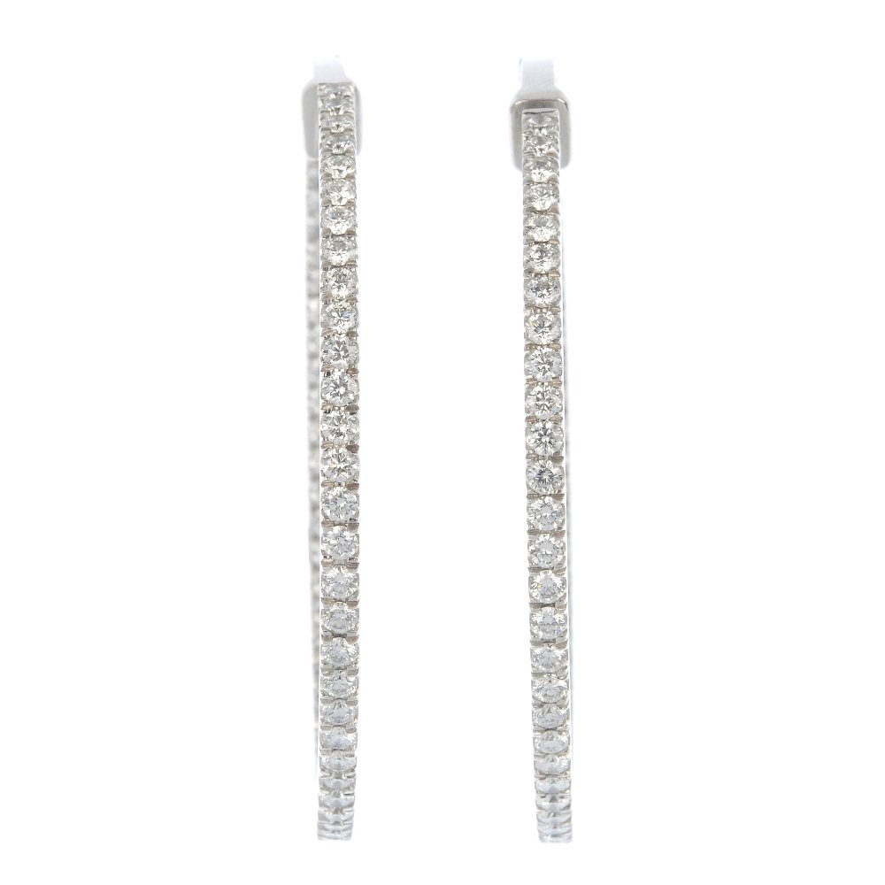 BOODLES - a pair of 18ct gold diamond ear hoops.: BOODLES - a pair of 18ct gold diamond hinged ear hoops. Each designed as a brilliant-cut diamond line, to the similarly-set inside half-hoop. Signed Boodles. Total diamond weight 4.41cts, stamped to i