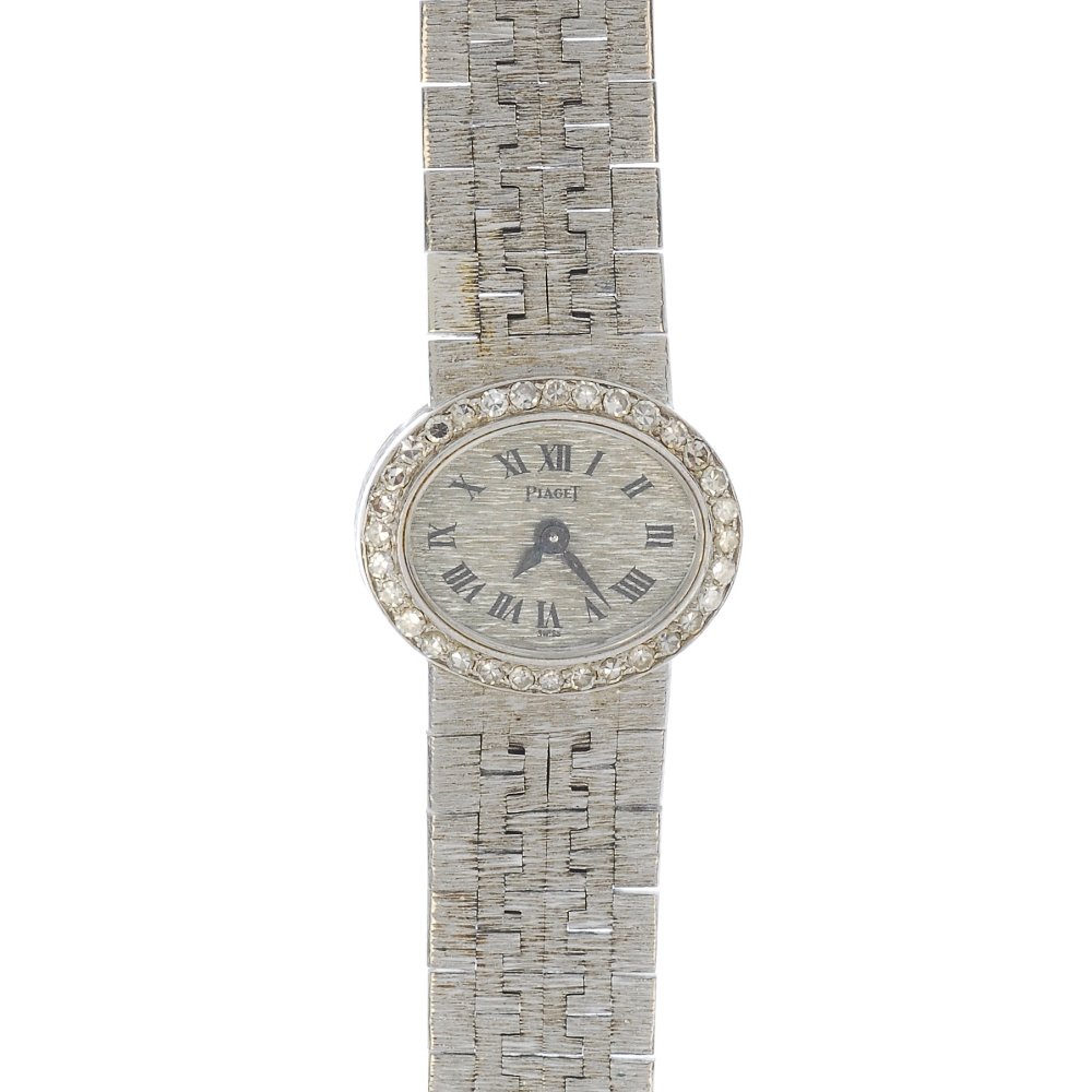 PIAGET - a ladies 18ct gold diamond wristwatch.: PIAGET - a ladies 18ct gold diamond wristwatch. The oval-shape textured dial, with black Arabic numerals, to the single-cut diamond bezel and similarly-textured bracelet. Estimated total diamond weigh