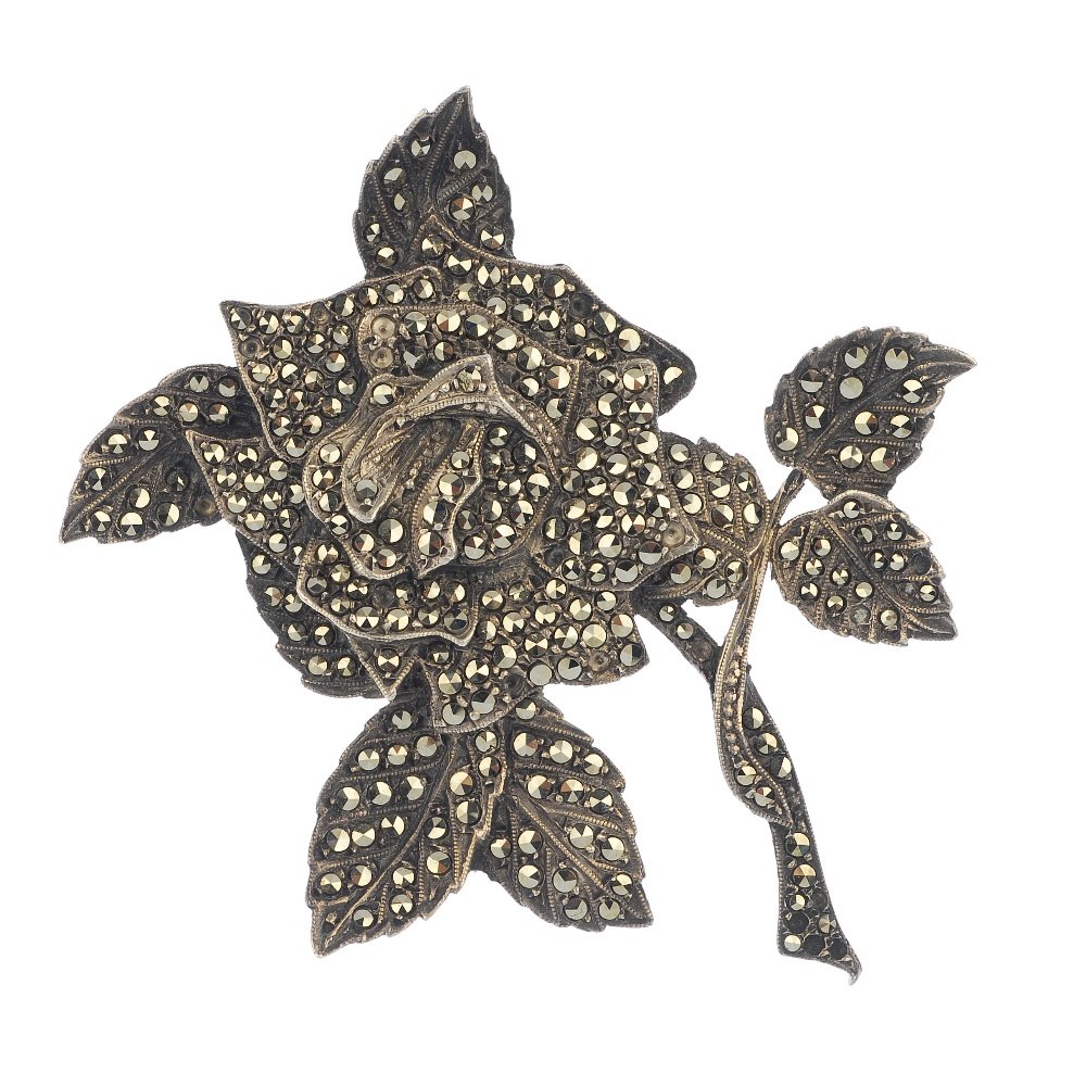 A marcasite brooch, two paste brooches and three paste: A marcasite brooch designed as a rose, a crescent-shape paste brooch, a further paste brooch and three paste buckles. Lengths 3.2 to 6cms.