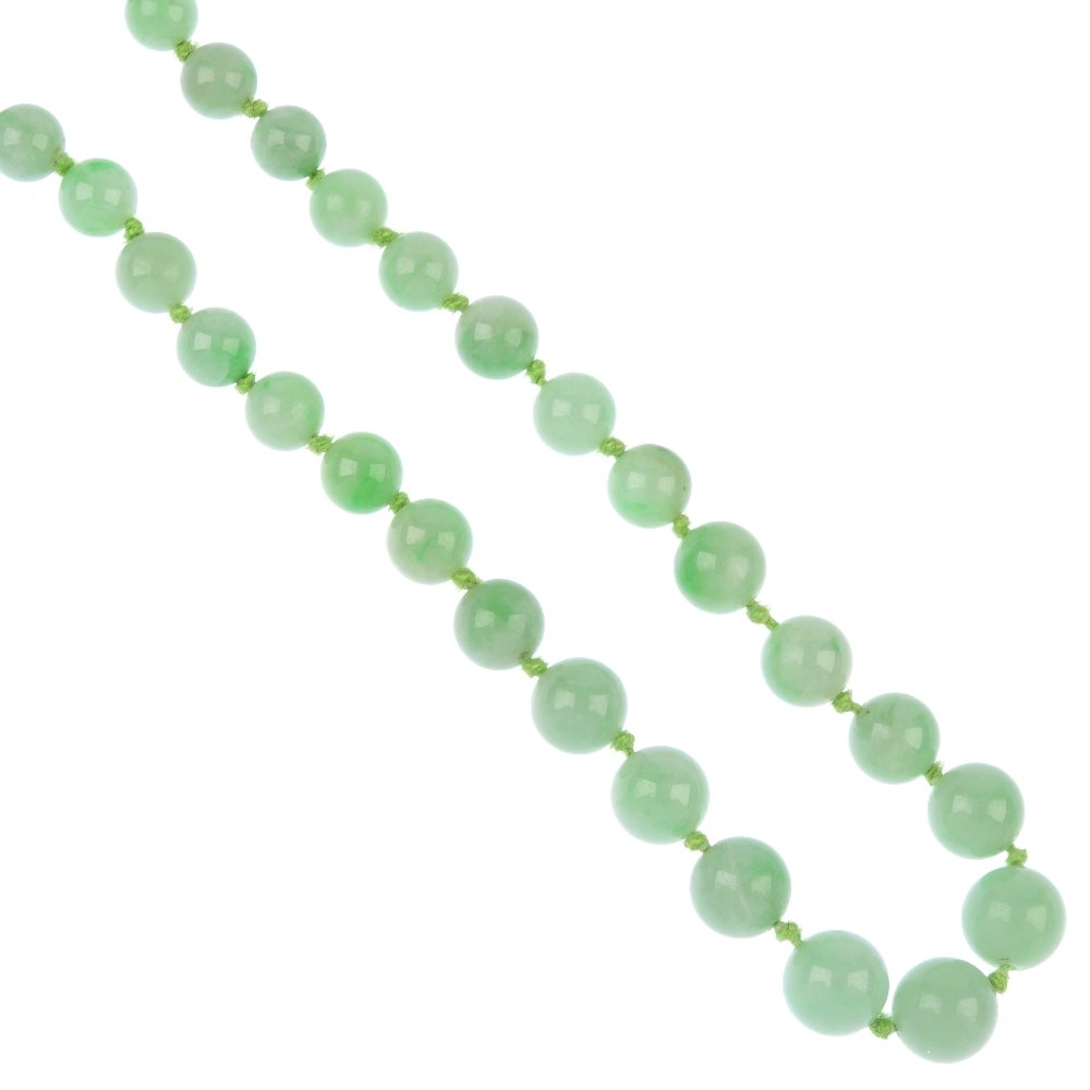 A jade bead single-strand necklace.: A jade single-strand necklace, comprising a graduated series of forty-nine jadeite beads, measuring from 4.6 to 9.6mms, to the base metal spring-ring clasp. Untested for natural colour. Length 43.5cms