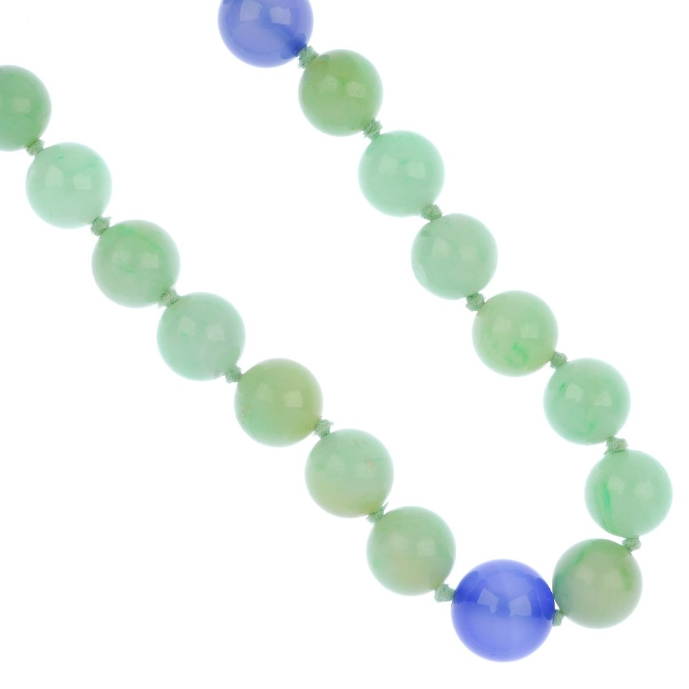 A jade and dyed chalcedony bead necklace.: A jade and dyed chalcedony bead necklace, comprising a single strand of forty jadeite beads, with five dyed chalcedony bead spacers, to the spring ring clasp. Jade untested for natural colour origin.