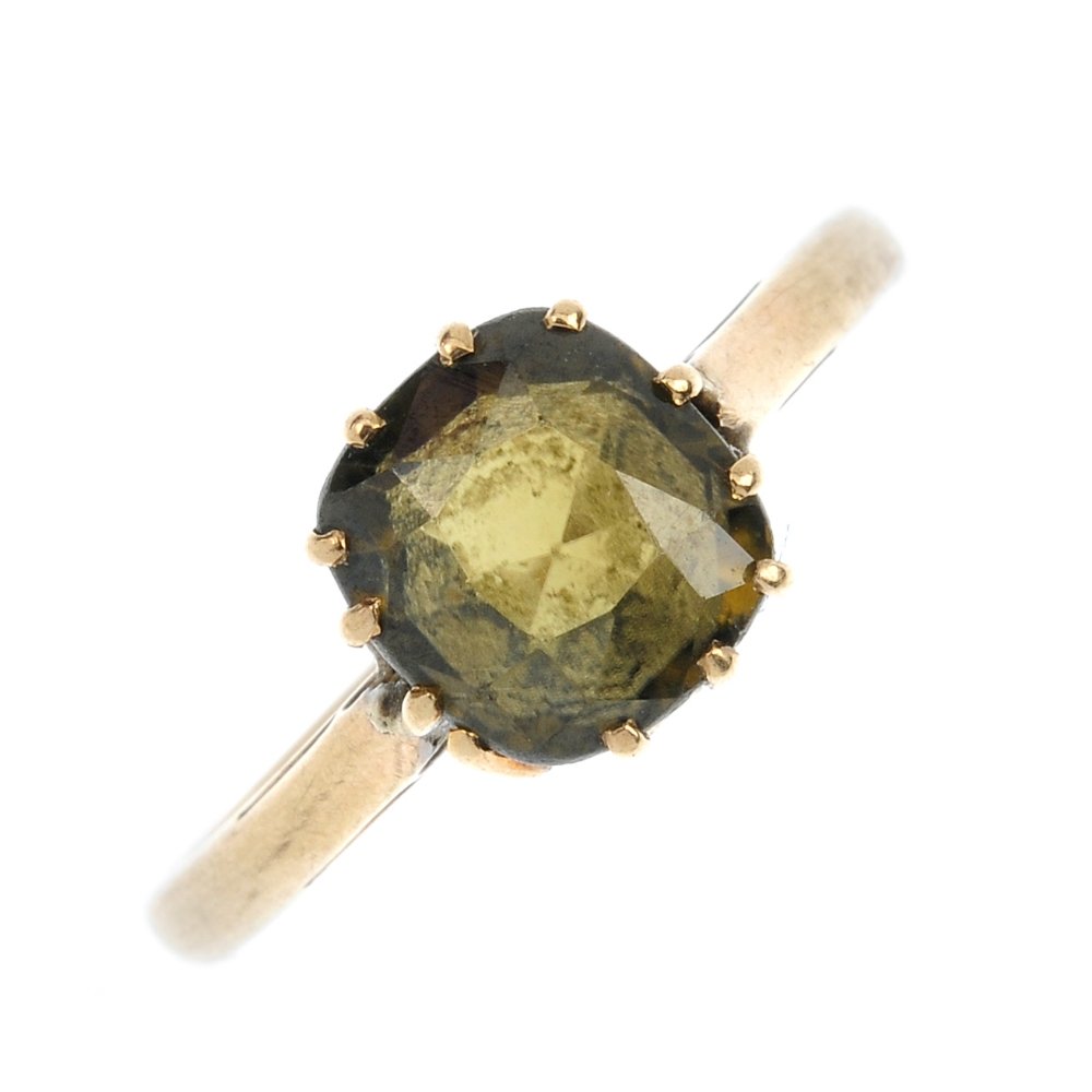 An early 20th century 9ct gold zircon single-stone ring: An early 20th century 9ct gold zircon single-stone ring. The cushion-shape dark green zircon, to the plain band. Weight 2.3gms.