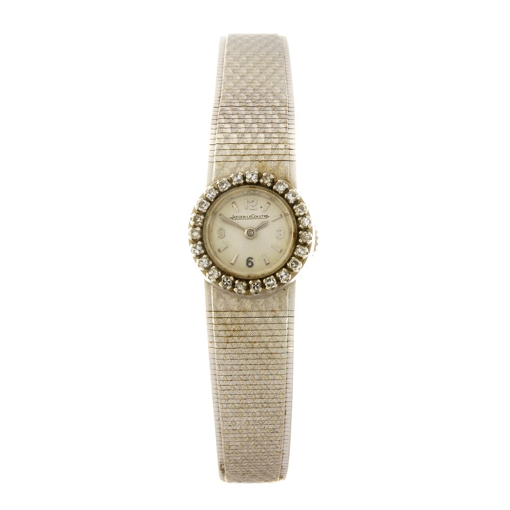 (131148686) JAEGER-LECOULTRE - a lady's bracelet watch.: (131148686) JAEGER-LECOULTRE - a lady's bracelet watch. Stamped 750 with poincon. Signed manual wind movement. Silvered dial with baton hour markers, quarterly Arabic numerals. Diamond set bezel, whit