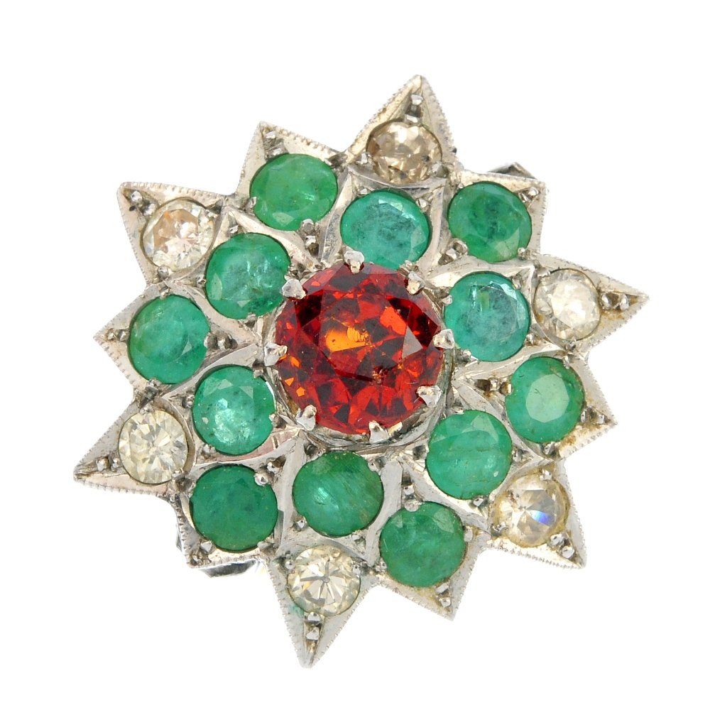 A garnet, emerald and diamond dress ring.: A garnet, emerald and diamond dress ring. The circular-shape orange garnet, to the circular-shape emerald and brilliant-cut diamond star-shape panel and bi-colour shoulders. Estimated total diamond we