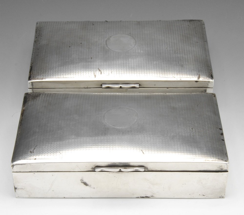 A pair of early 20th century silver mounted jewellery: A pair of early twentieth century silver mounted jewellery boxes of rectangular outline, each hinged lid with engine turned decoration surrounding a central circular panel and opening to reveal a velv