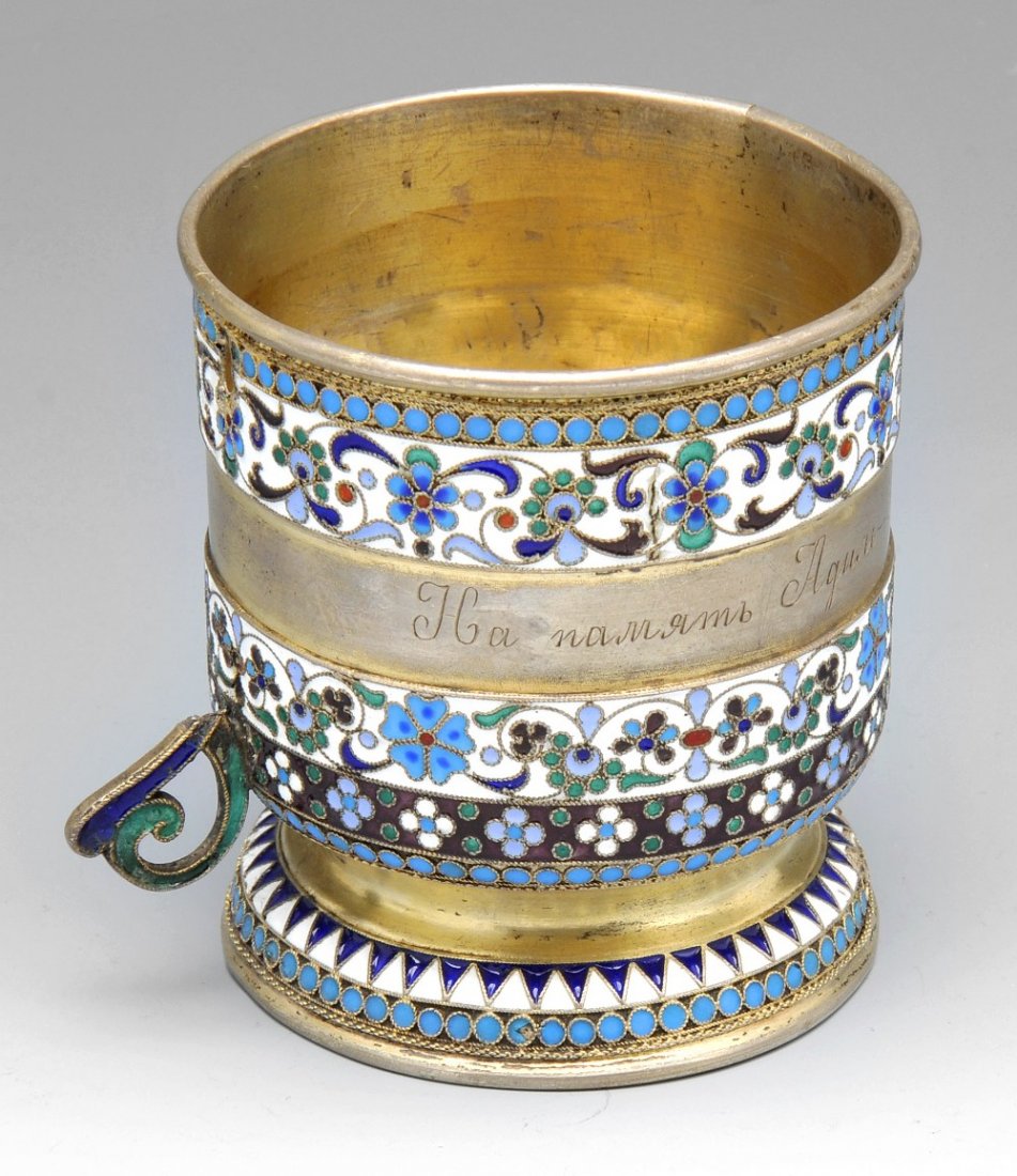 Russian silver christening mug & vodka cups.: An early twentieth century Russian silver-gilt and cloisonné enamel christening mug with personal inscription, missing handle (AF), marked with the Kokoshnik mark (1908-1926), height measuring 3 inch