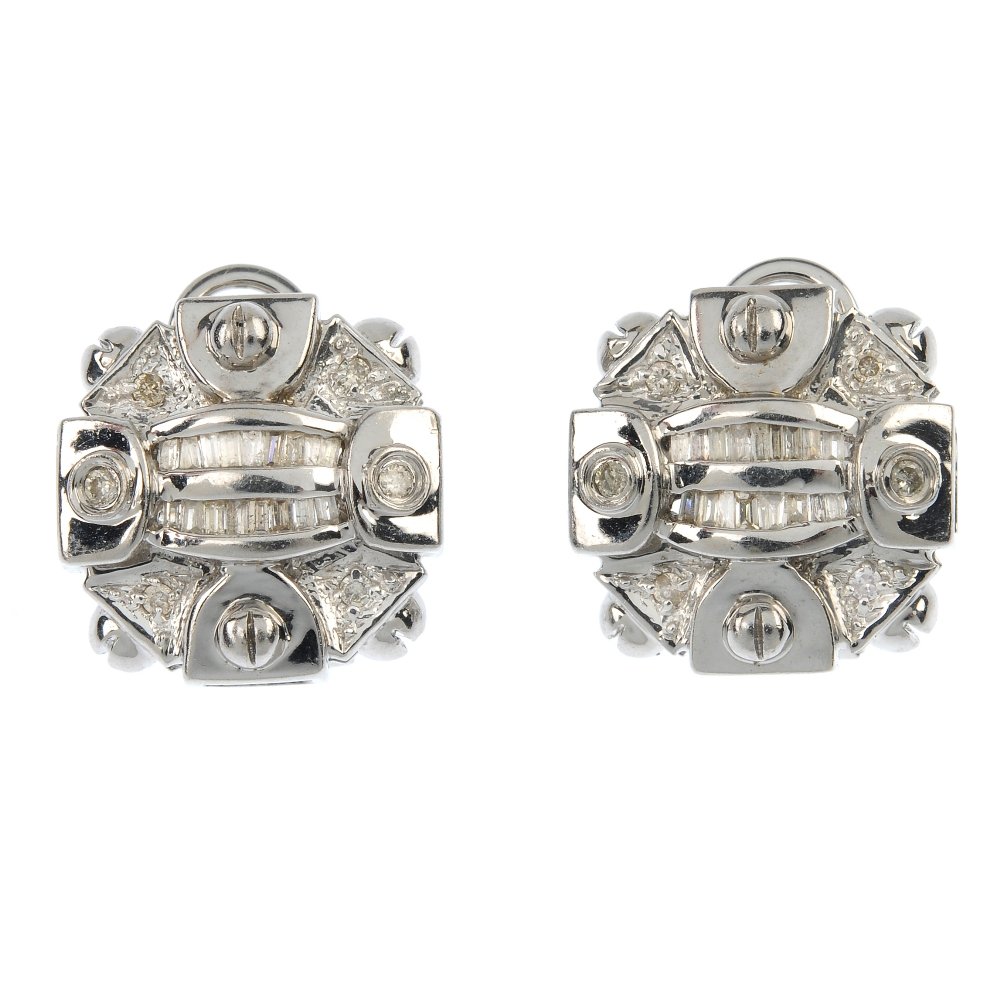 A pair of diamond earrings.: A pair of diamond earrings. Each designed as a baguette-cut diamond double line, within a brilliant-cut diamond geometric surround. Estimated total diamond weight 0.35ct. Length 1.5cms. Weight 8.3gms.