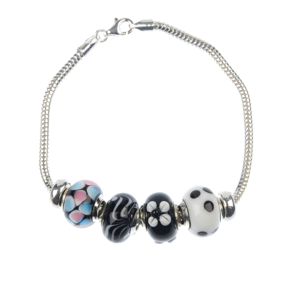 Twenty-six charm bracelets.: Twenty-six charm bracelets, each designed as a snake chain to the lobster-claw clasp each suspending four decorative glass beads. Most with marks to indicate silver. Total weight 487gms.