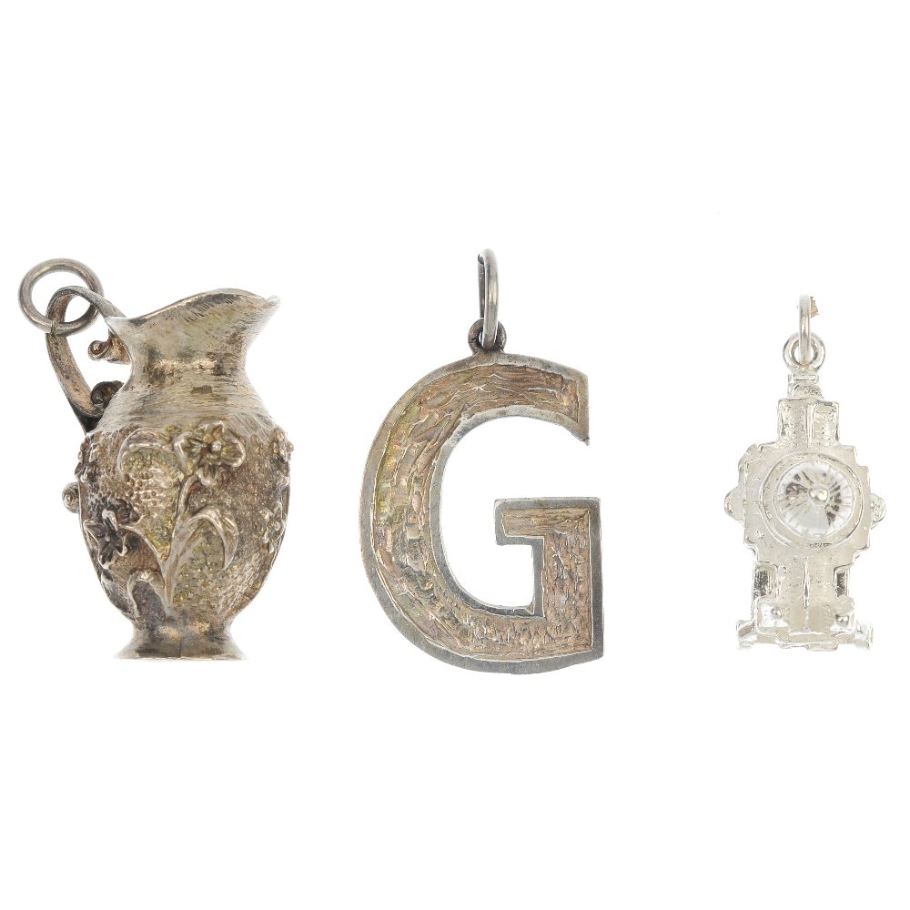 A selection of silver and white metal charms.: A selection of silver and white metal charms, the sixty-eight charms to include, a rocket-ship, a wine jug and a ship in a bottle. Some with marks to indicate silver. Lengths 1.5 to 3.3cms. Total weig