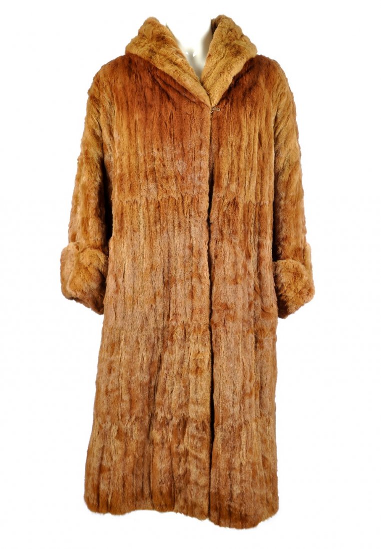 An ermin fur coat: A knee-length ermine fur coat with large lapel collar, three-quarter length wide sleeves with stitched, rolled-up cuffs, hook and eye fastenings, two outer pockets and inner ribbon tie. Labelled Faulk