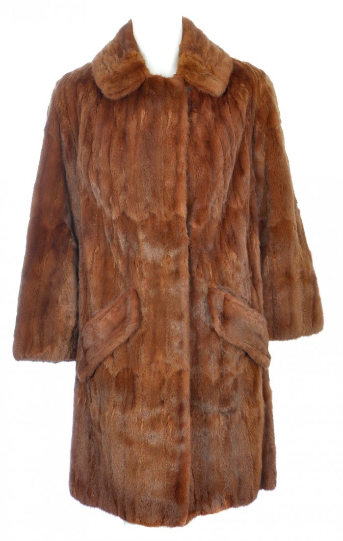 A dyed ermine coat: A knee-length dyed ermine fur coat with notched lapel collar, hook and eye fastenings, cocktail cuffs, half belt, two outer flap pockets, one inner patch pocket and an inner ribbon tie. Labelled Faulk