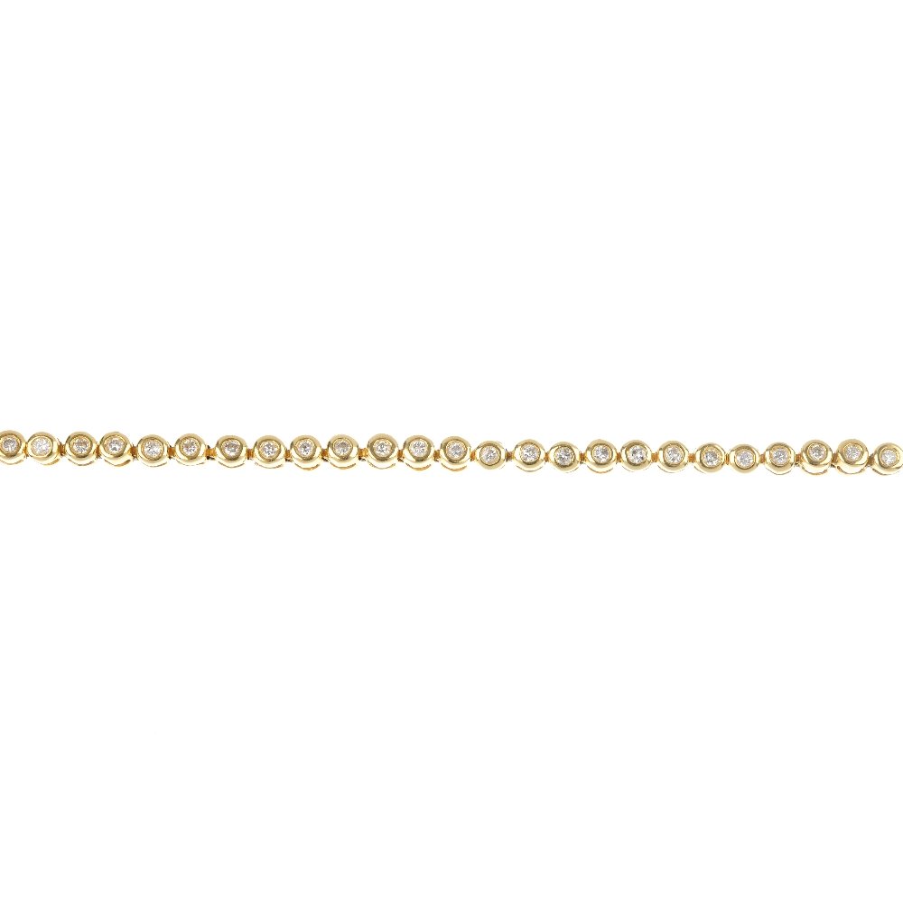 An 18ct gold diamond line bracelet.: An 18ct gold diamond line bracelet. Designed as a series of fifty-seven brilliant-cut diamond collet links, to the partially concealed clasp. Estimated total diamond weight 1.15cts. Hallmarks partiall