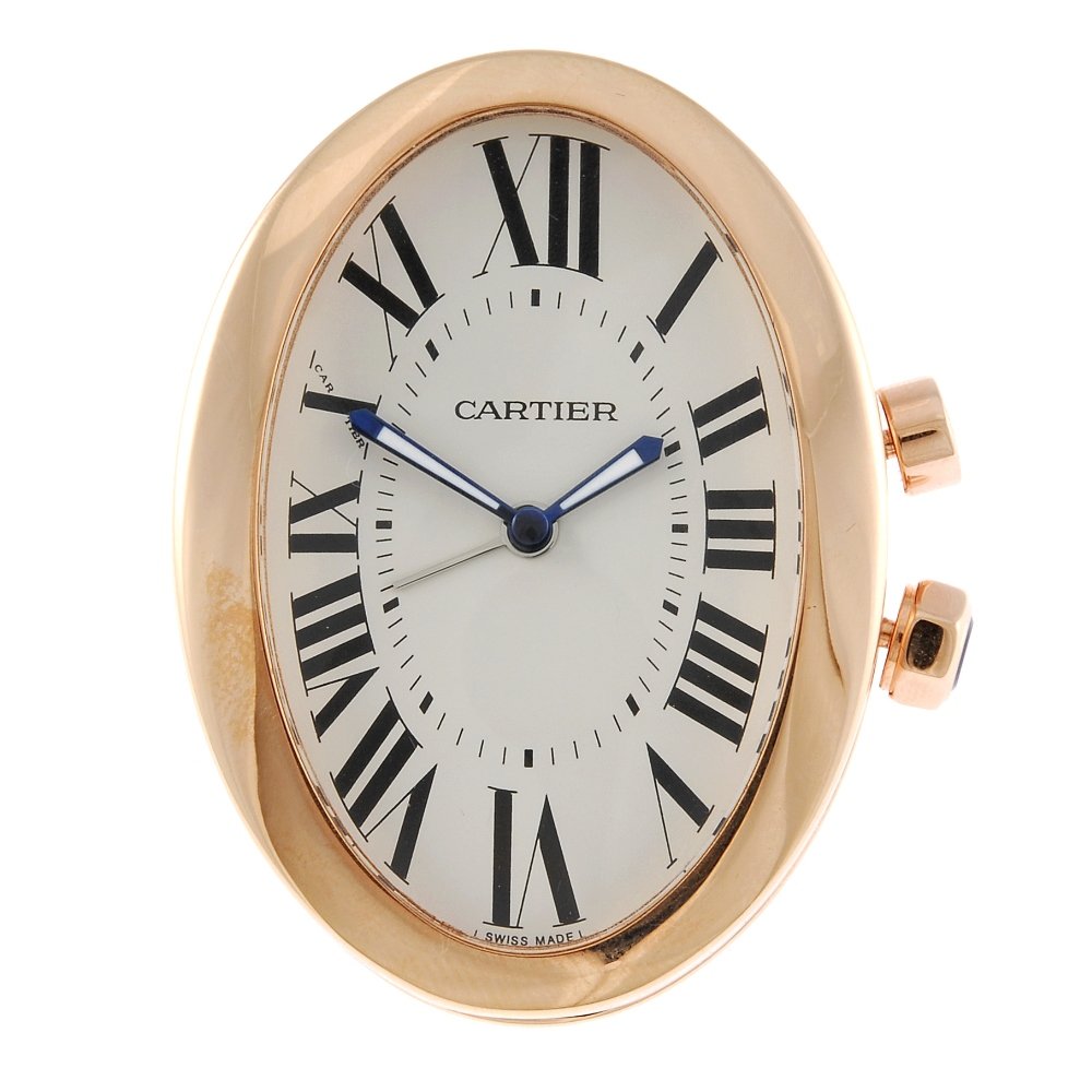 A travel alarm clock by Cartier.: A travel alarm clock by Cartier. Numbered 701289GD 3111. Quartz movement. Silvered dial with Roman numeral hour markers. Rose gold capped case. 37mm. Box and papers.