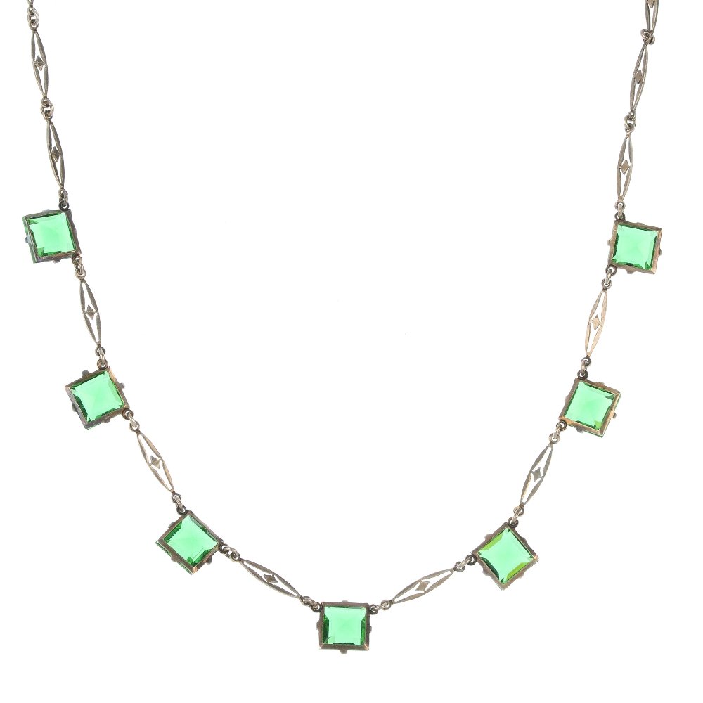 Two paste necklaces.: Two paste necklaces, to include an early 20th century necklace designed as elongated pierced links interspaced by square green pastes, the second designed as a faceted green and colourless paste bead