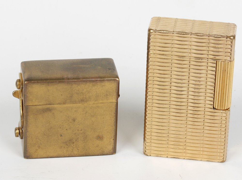 A gold plated Dupont gas lighter: A gold plated Dupont gas lighter, the case engraved with initials ES, together with a Dupont plated cigar cutter, the rounded oblong body with sprung side wings flanking a central aperture, signed ben