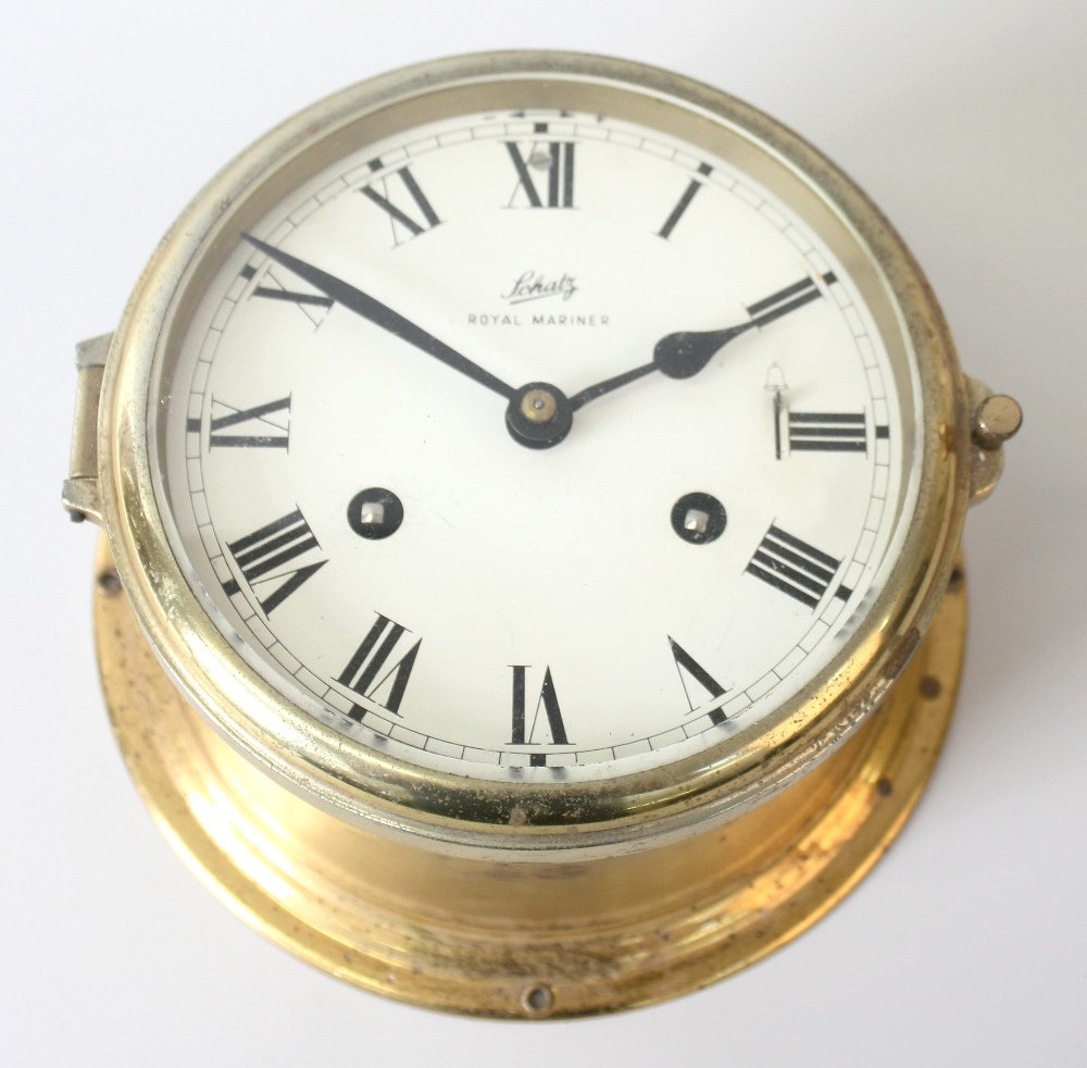 A box containing assorted clocks: A box containing assorted clocks. To include: a Royal Schutz bulkhead-style timepiece, a French black slate clock, two oak-cased 'Napoleon's hat' type clocks, two wall clocks, etc.