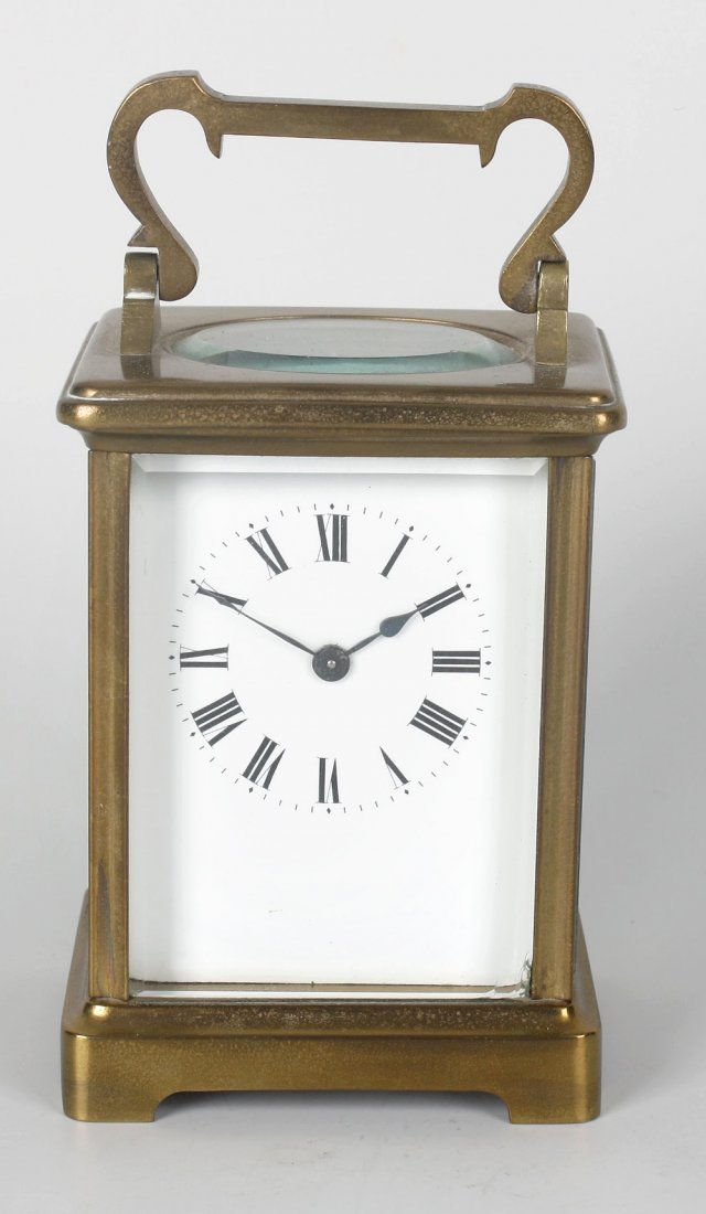 A ship's brass bulkhead clock, Smith Astral (Coventry) : A ship's brass bulkhead clock, Smith Astral (Coventry) for Dobbie McInness, with 5.5-inch Roman dial having subsidiary seconds beneath XII, together with a corniche-cased carriage timepiece. (2).