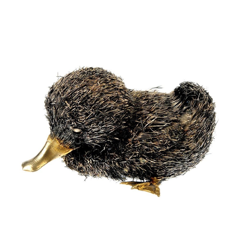 BUCCELLATI - a 1970's silver gilt duck ornament.: BUCCELLATI - a 1970's silver gilt duck ornament. Designed as a sitting duck, with a textured body and gilded appendages. One foot deficient. Length 11cms. Weight 111.9gms.