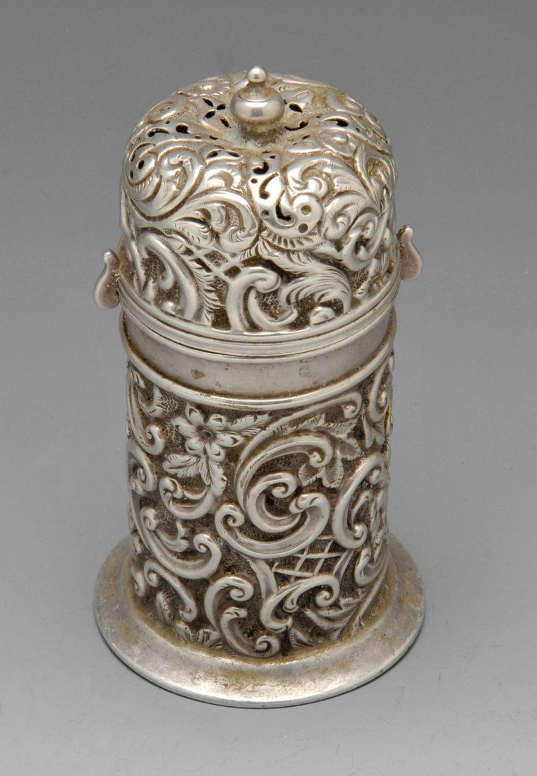 A late Victorian silver lighthouse caster.: A late Victorian silver lighthouse caster, ornately embossed throughout with foliate scroll and floral motifs, the cover with bayonet lock fitting. Hallmarked William Harrison Walter, Chester 1895. He