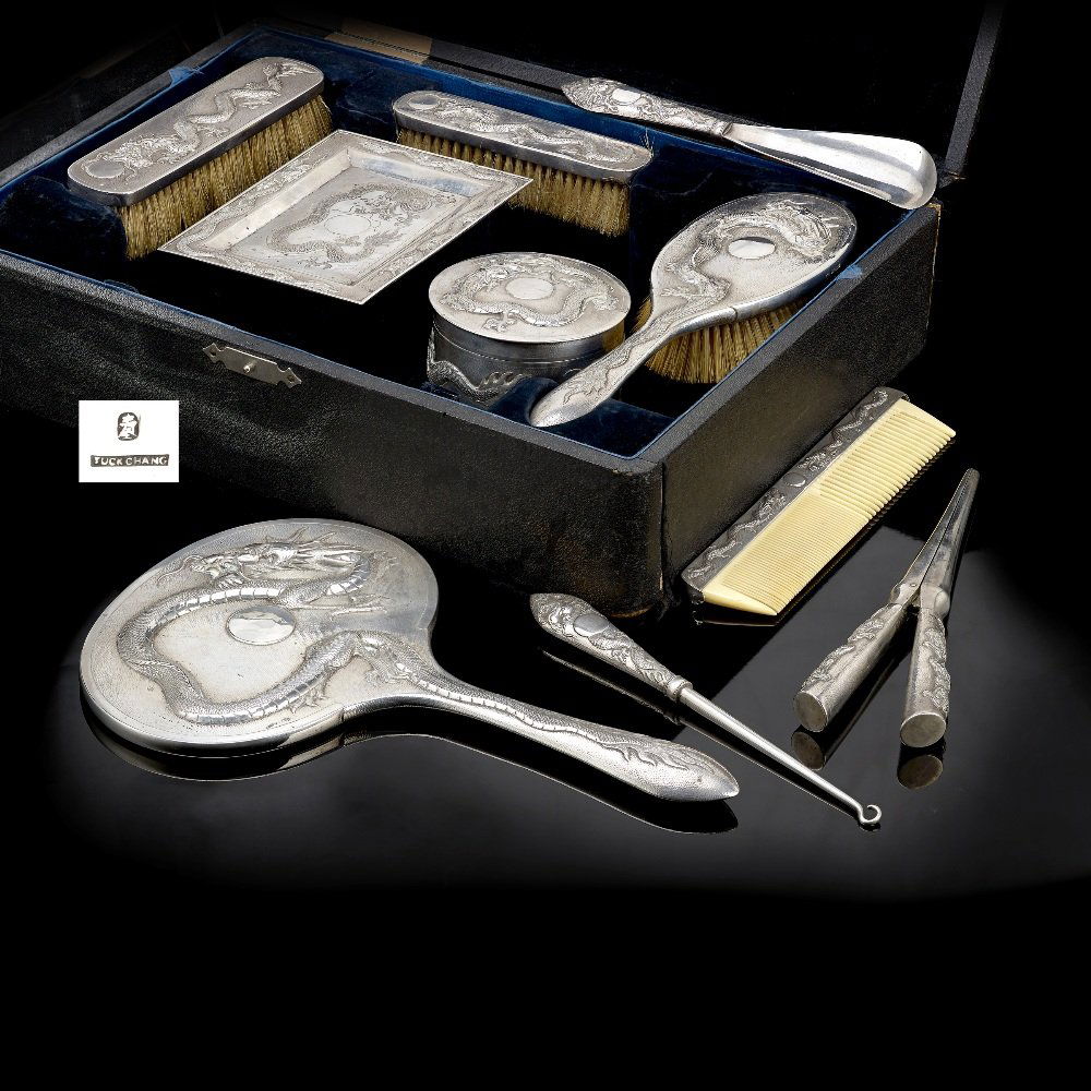 Chinese Export dressing table set, by Tuck Chang, cased: A turn of the century Chinese export cased ten piece silver dressing table set comprising hand mirror, shoe horn, button hook, glove stretchers, hair brush, two graduated clothes brushes, trinket tray