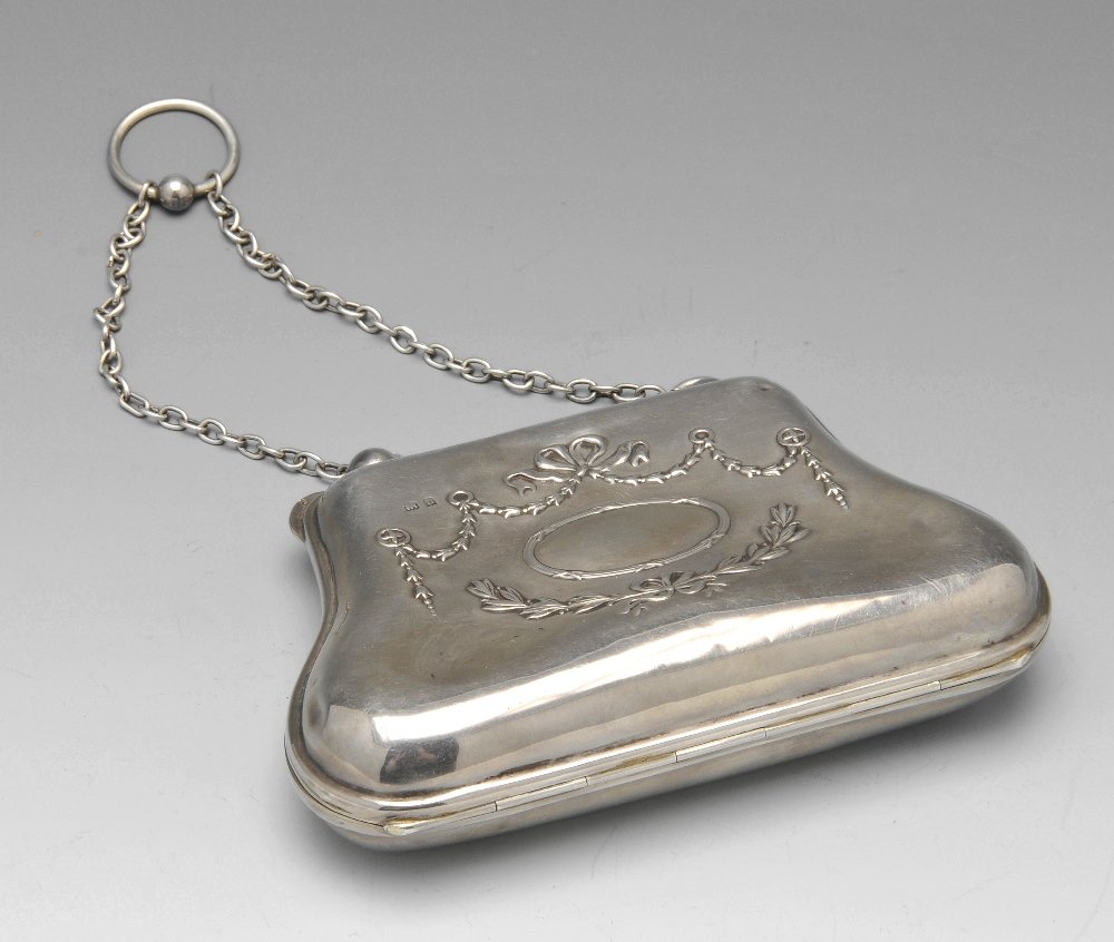 A selection of four purses & a base metal chatelaine.: An Edwardian silver purse of shaped outline and decorated to the front with ribbon tied swag motifs, opening to a faux silk lined interior with compartments and a further silver mount, hallmarked Henr