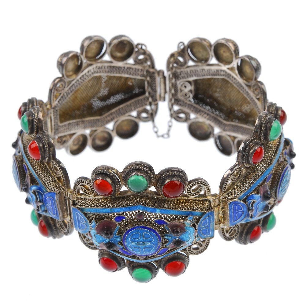 An enamel and paste bracelet.: An enamel and paste bracelet, designed as five openwork panels, each with enamel and paste details. Length 17.5cms.