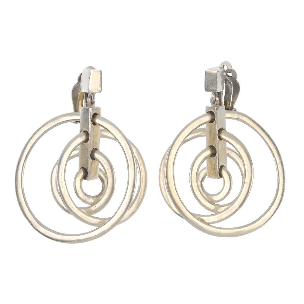 ANTONIO PINEDA - a pair of ear clips.: ANTONIO PINEDA - a pair of ear clips, each designed as four graduated hoops, suspended from a rectangular bar, to the rectangular surmount. Signed Antonia, Taxco. Length 5.9cms. Weight 40.8gms.