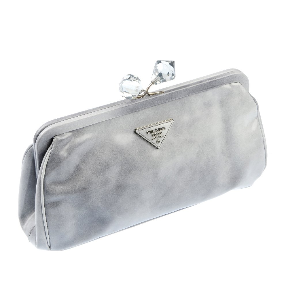 PRADA - jewel clasp clutch bag: PRADA - an evening clutch bag with smoke effect smooth leather exterior, maker's logo plate, large faceted clasp clip closure and two interior compartments. Measures 9 by 15 by 30cms. With maker's dus