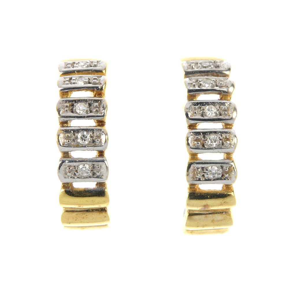 A pair of diamond earrings.: A pair of diamond earrings. Each of bi-colour design, the sectional curved line, with single-cut diamond accents. Length 1.6cms. Weight 2.6gms.