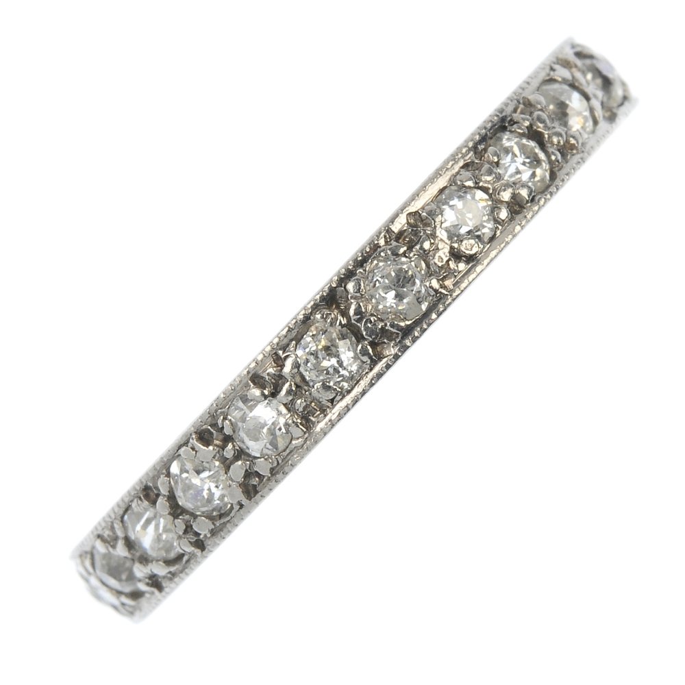 A mid 20th century platinum diamond full-circle: A mid 20th century platinum diamond full-circle eternity ring. Designed as a series of old-cut diamonds, to the engraved gallery. Estimated total diamond 0.90ct. Ring size P. Weight 5gms.