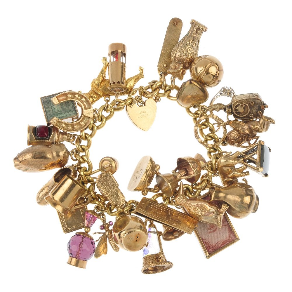A 9ct gold charm bracelet with thirty-one charms.: A 9ct gold charm bracelet. Suspending a series of thirty-one charms, to include a cheque-book charm, a hand-held camera charm and a dog charm. Sixteen with hallmarks for 9ct gold. Length of bracelet 1