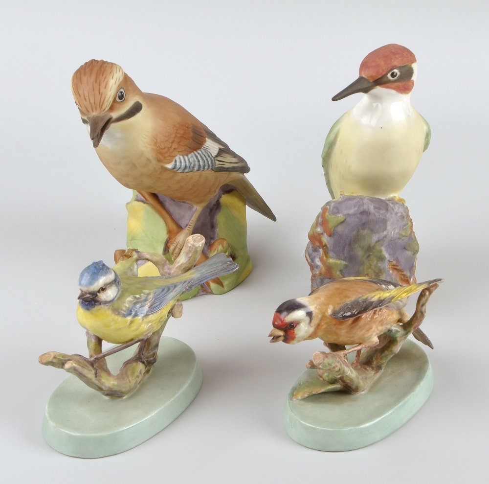 A group of twelve Royal Worcester studies of birds: A group of twelve Royal Worcester studies of birds, to include 'Blue Tit' and 'Goldfinch', each inscribed beneath 'Modelled by Doris Lindner', plus 'Wren', 'Woodpecker', etc, each with printed mark be