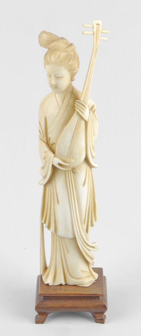 A Japanese Meiji period ivory figure of a kabuki: A Japanese Meiji period ivory figure of a kabuki musician, the female figure with top-knot, dressing in floor length robes and holding a traditional four-stringed biwa lute, 9.5" (24cm) high on a wood