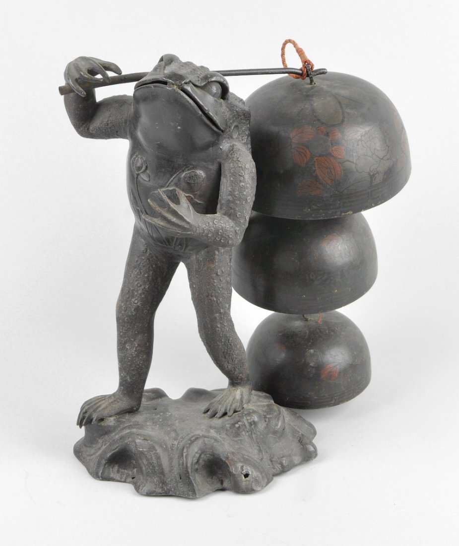 An unusual early 20th century spelter frog dinner bell: An unusual early 20th century spelter frog dinner bell or gong, modelled in standing pose carrying a pole upon his right shoulder with a graduated stack of three bells, 11" (28cm) high.