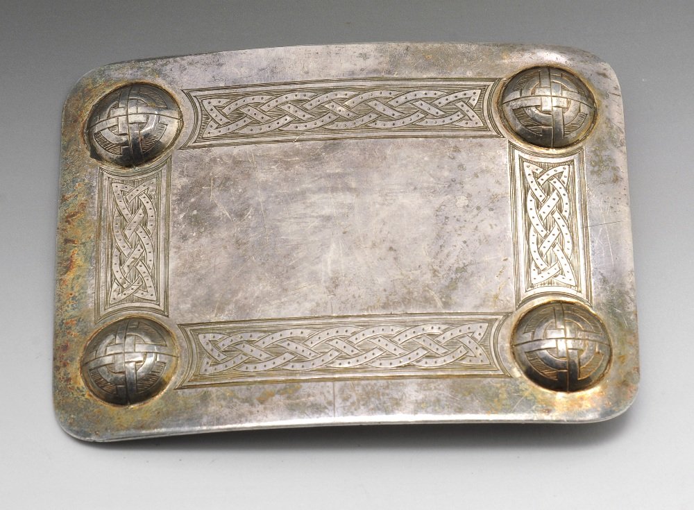 A modern Scottish silver belt buckle, etc.: A modern Scottish silver belt buckle with traditional Celtic border, hallmarked T K Ebbutt Ltd, Edinburgh 1979, length measuring 3 3/4 inches (9.5 cm). Together with a modern silver miniature scent bo