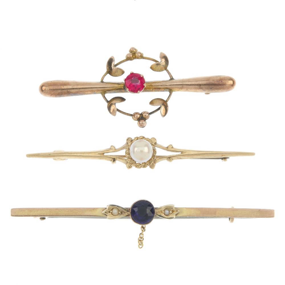 A selection of three gem-set bar brooches.: A selection of three gem-set bar brooches. To include two early 20th century 9ct gold paste and floral accent bar brooches, together with a cultured pearl bar brooch. Lengths 5.9 to 4.5cms. Total weig