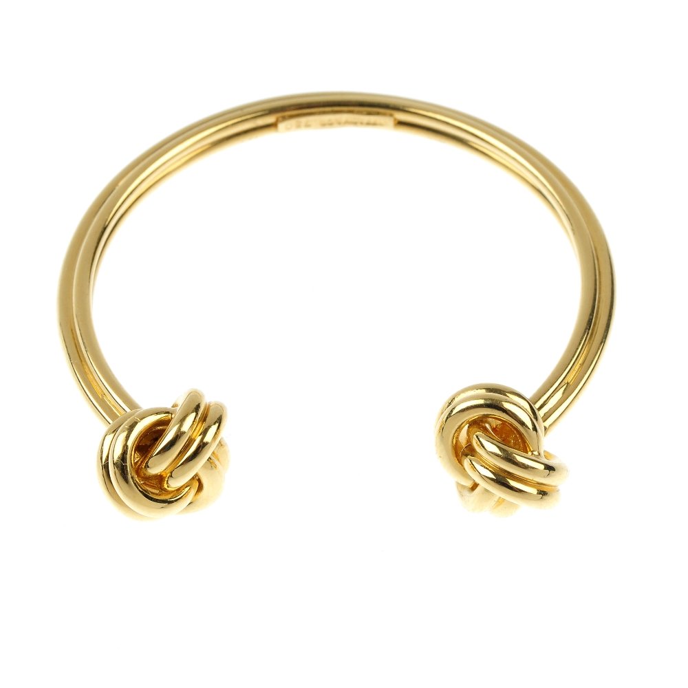 TIFFANY & CO. - a key ring.: TIFFANY & CO. - a key ring. Designed as a grooved circlet, with knot terminals. Signed Tiffany & Co. Diameter 3.8cms. Weight 13.8gms.