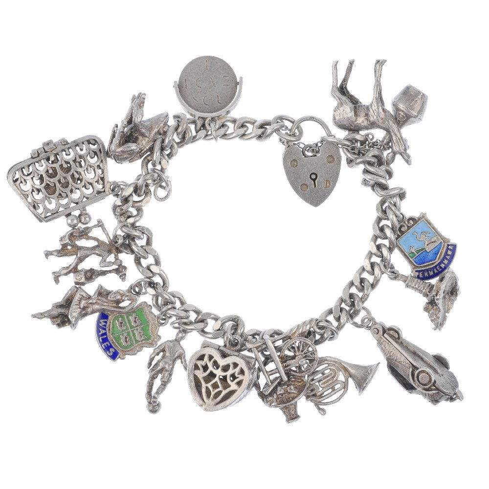 Two charm bracelets.: Two charm bracelets, the curb-link bracelets suspending a total of twenty charms, to include a spinning wheel and a frog, one wth a heart padlock clasp and one with a spring release clasp. One clasp A