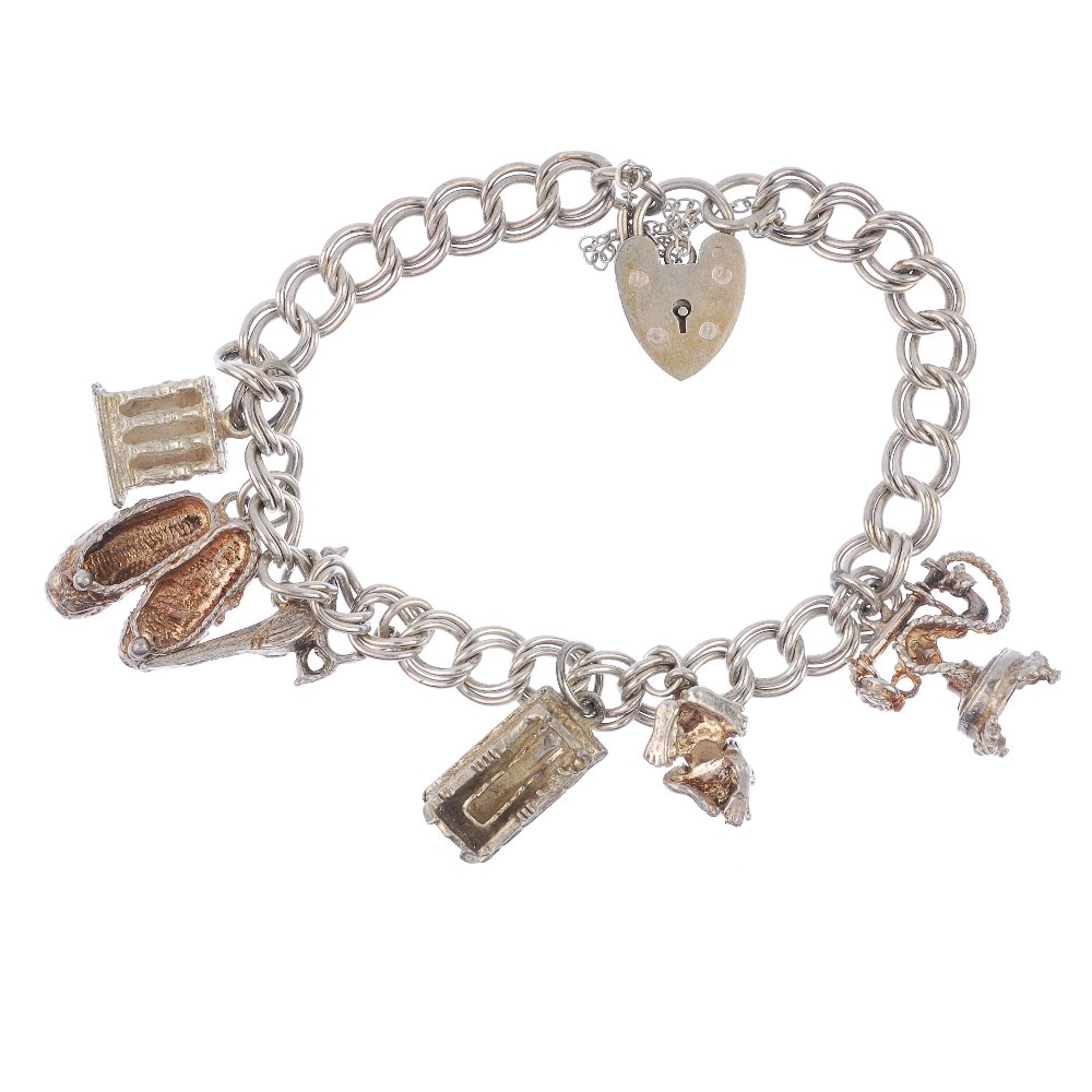 Two charm bracelets and four loose charms.: Two charm bracelets and four loose charms, the curb-link and double curb-link bracelets suspending nine charms to include a windmill and a tractor, together with four loose charms, both bracelets with