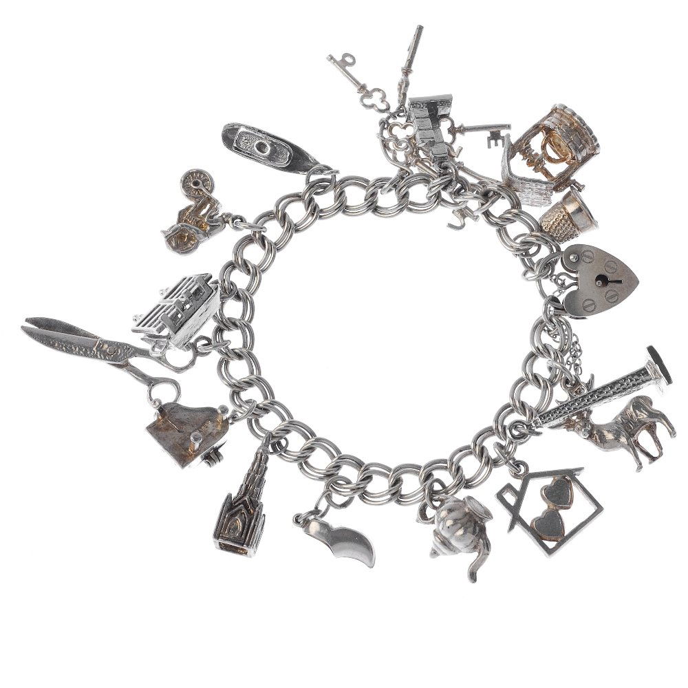 Two charm bracelets.: Two charm bracelets, the curb-link bracelets suspending twenty-four charms, to include a stag, a clam and a thimble. Some with marks indicating silver. Total weight 90.8gms.