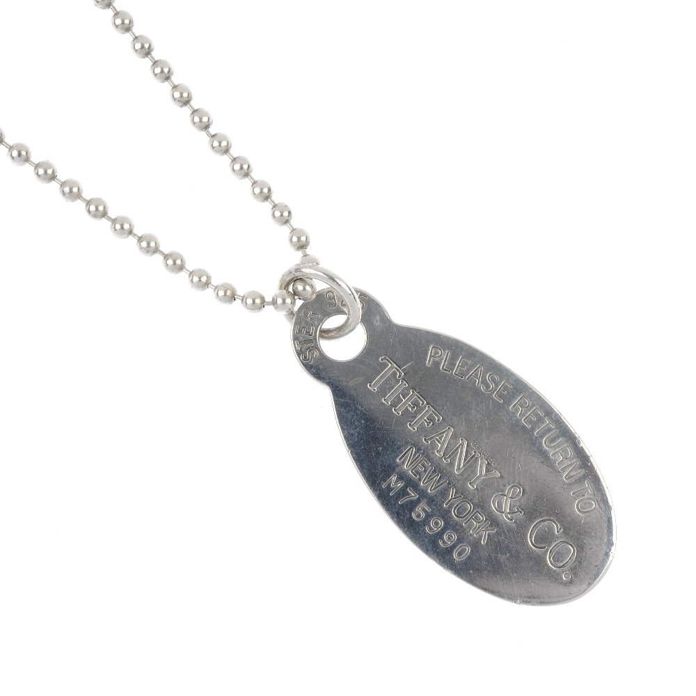 TIFFANY & CO. - a silver tag pendant and chain and an: TIFFANY & CO. - a silver 'Return to Tiffany' tag pendant and bead chain, together with an Elsa Peretti 'Teardrop' ring. Maker's marks for Tiffany & Co. Length of chain 85cms. Tag and chain with hallma