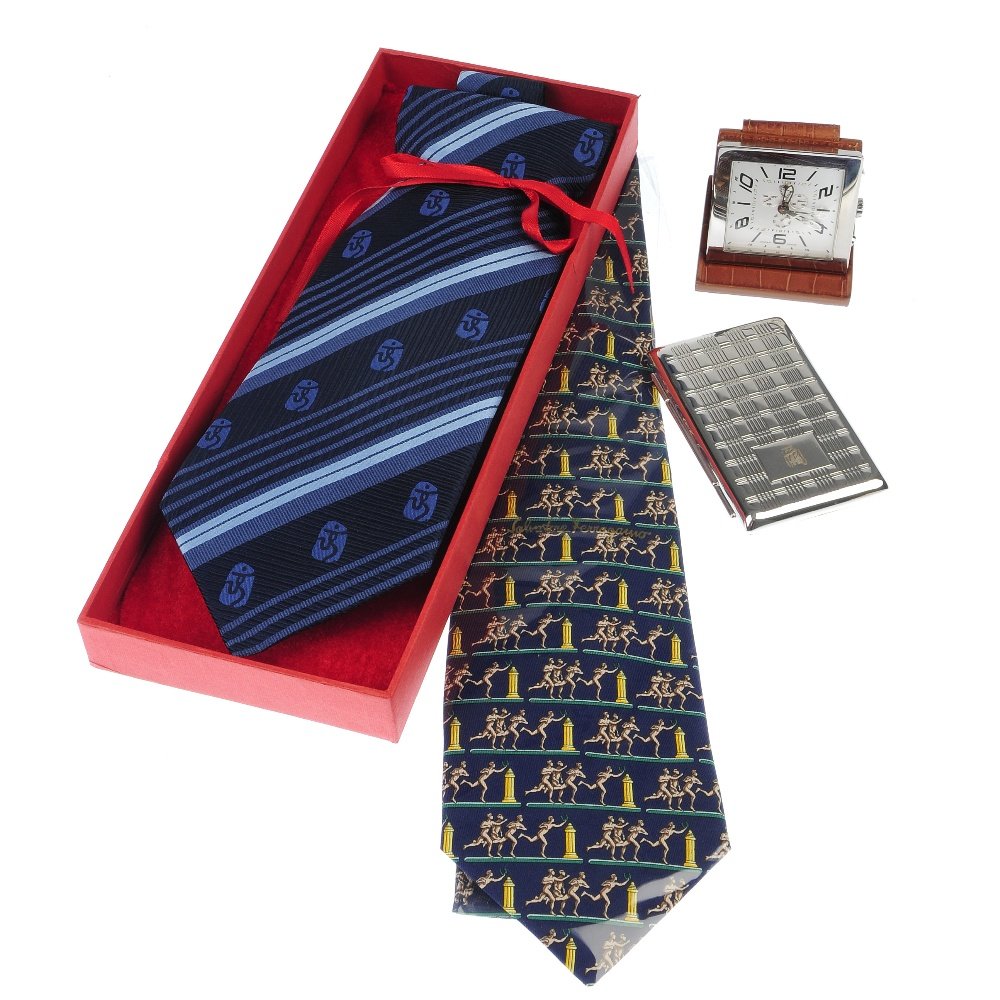 A Links of London folding photograph frame, a Swiss: A selection of four gentlemen's accessories, to include a silver plated Links of London folding travel photograph frame, a small Swiss made travel clock with fitted leather case, together with two tie