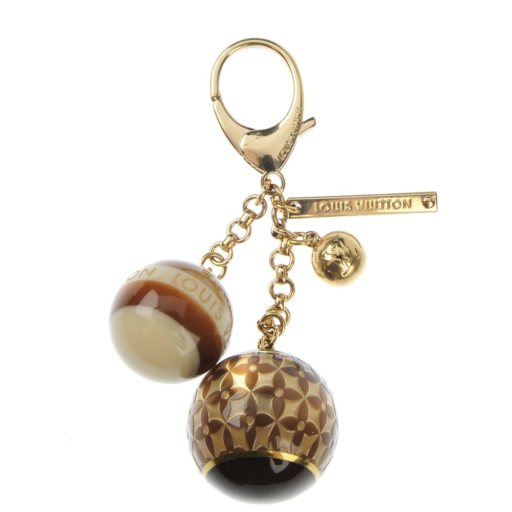 LOUIS VUITTON - a Mini Lin bag charm: LOUIS VUITTON - a Mini Lin bag charm, featuring three balls charms and maker's name plaque on an oversized lobster claw clasp.