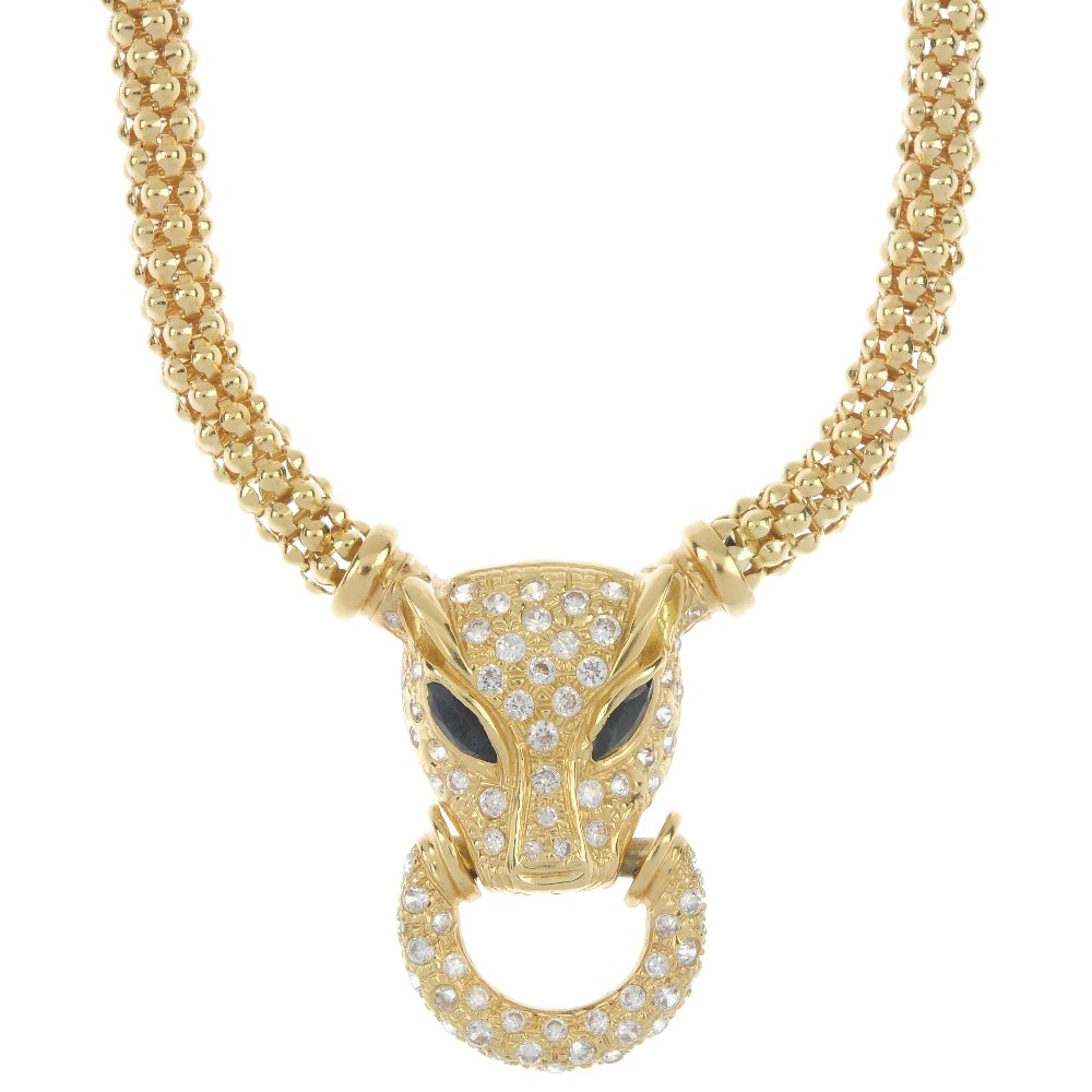A paste and sapphire leopard necklace.: A paste and sapphire leopard necklace. Designed as a colourless paste leopard head with marquise-shape sapphire eyes, to the similarly-set paste loop and fancy-link chain. Length 43cms. Weight 41gms.