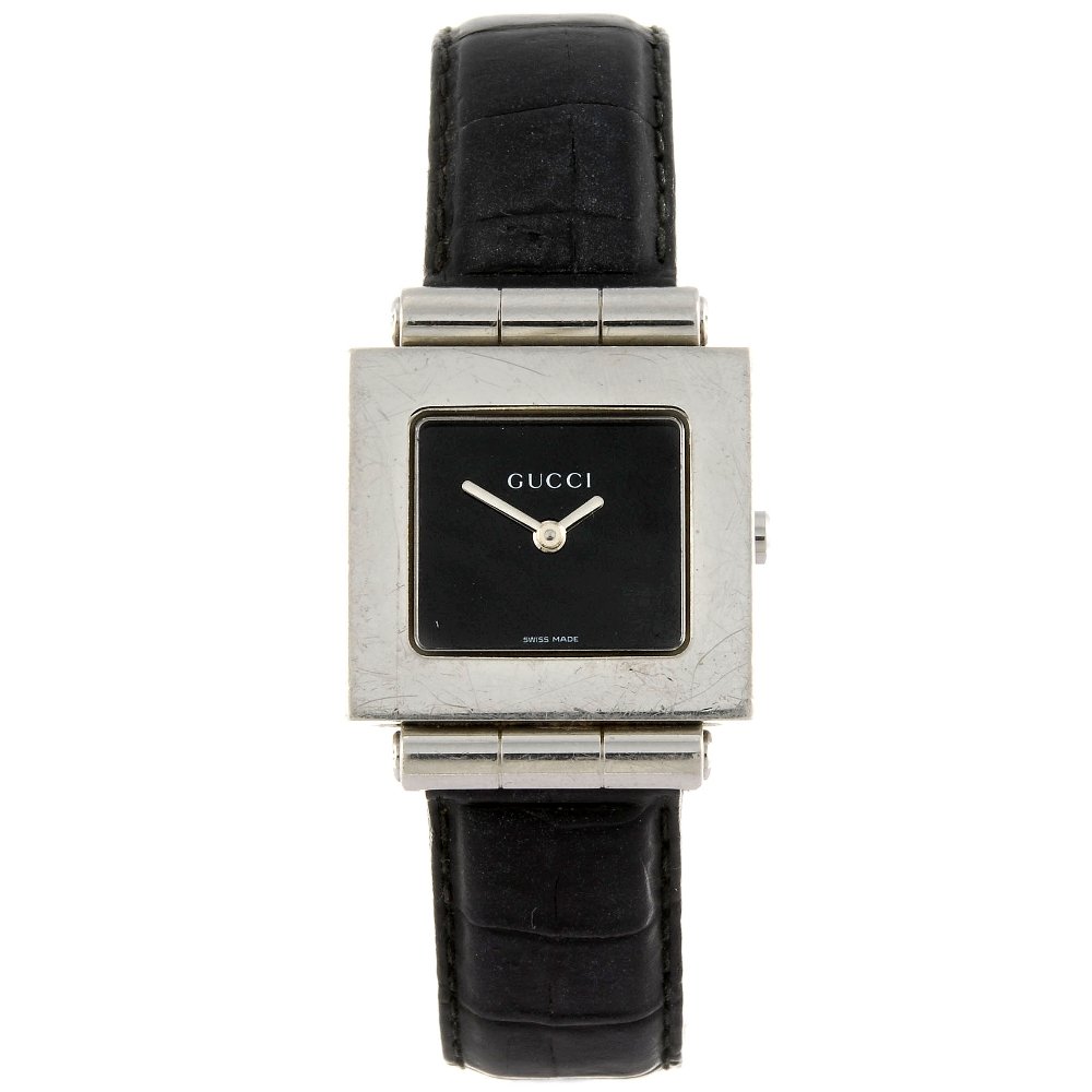 GUCCI - a 600J wrist watch with a DKNY bracelet watch: GUCCI - a 600J wrist watch. Numbered 0010241. Signed quartz movement. Black dial. Stainless steel case fitted to a signed black crocodile strap with stainless steel pin buckle. 24mm. Papers. Together