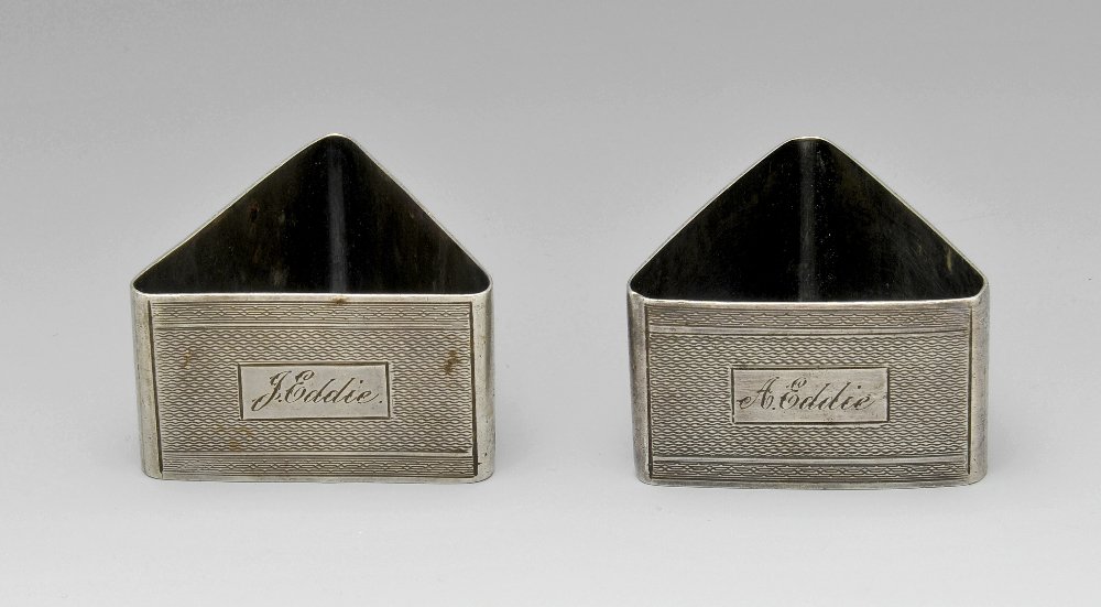 Four hallmarked napkin rings & two continental: A pair of 1930's silver napkin rings of triangular form with engine tuned decoration and personally engraved name panel, hallmarked Harman Brothers, Birmingham 1936. Together with two further napkin r