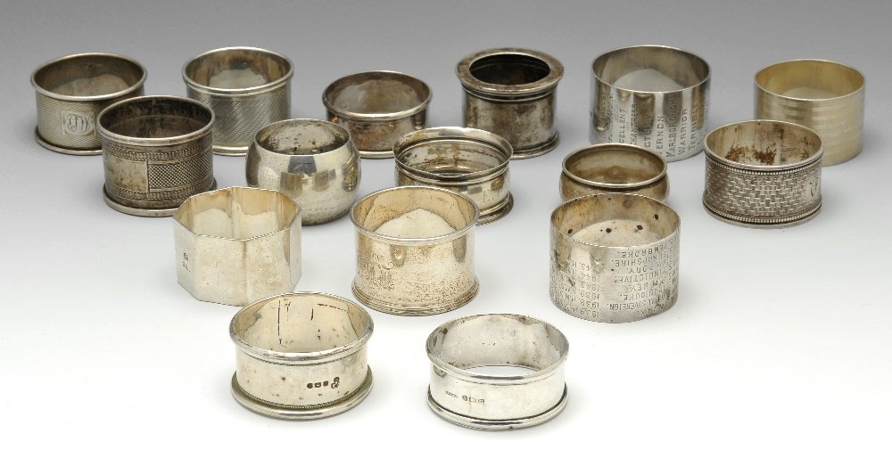 A selection of eighteen napkin rings.: A selection of sixteen silver napkin rings of various shapes and styles, mostly plain or with engine turned decoration, many with personal engravings, various hallmarks and makers. Together with two p