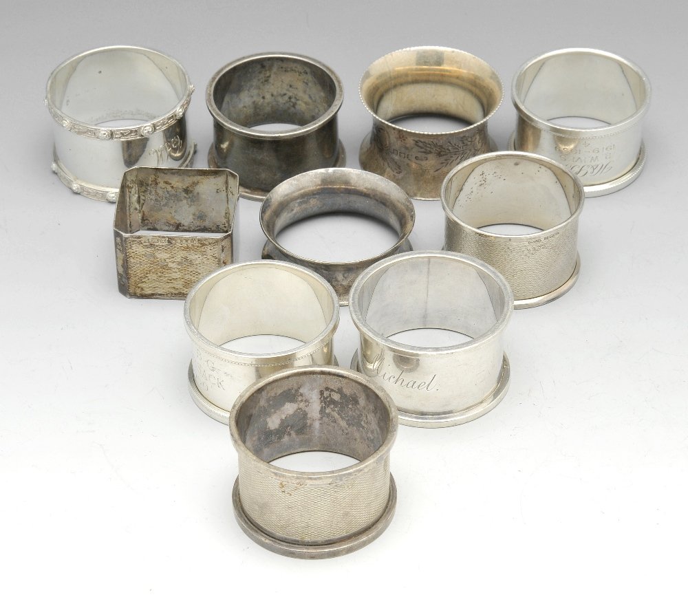 A selection of silver napkin rings.: A selection of twenty four Victorian and later silver napkin rings of various styles and hallmarks, many personally engraved, together with a further plated example. Gross weight 22 ozt (688 grams). (
