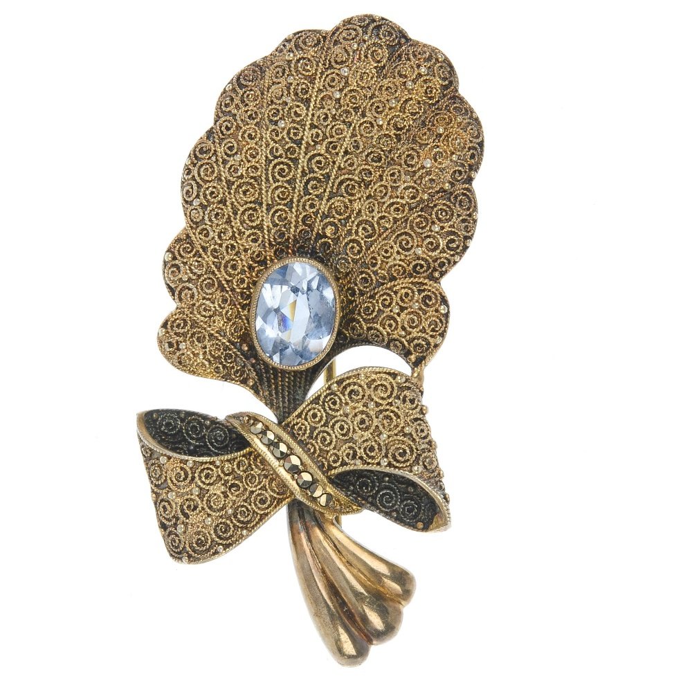 A selection of marcasite jewellery.: A selection of marcasite jewellery.To include a mid 20th century silver brooch designed as a stylised flower gathered with a marcasite bow, to the blue paste collet centre and scrolling detail. (22) S